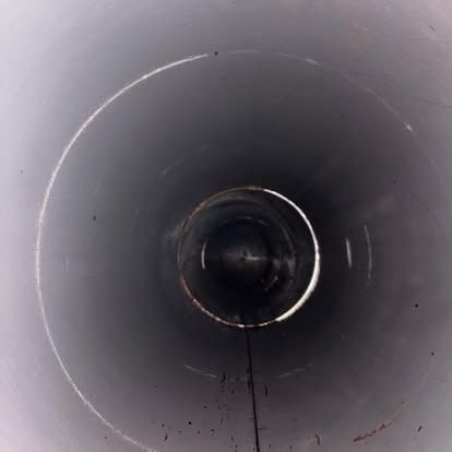 A close up of the inside of a metal pipe.