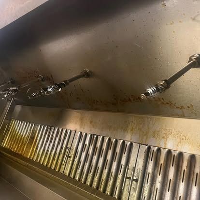 A close up of a stainless steel hood in a kitchen.