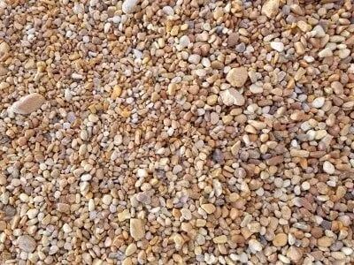 Small, rounded tan and light brown pebbles.