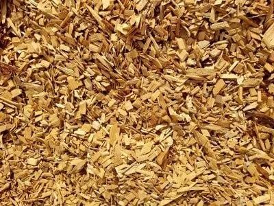 Wood chips, light brown and beige, scattered.