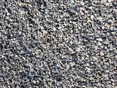 Close-up of a surface covered in small, gray gravel rocks.