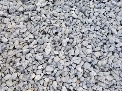 Close-up of light gray gravel, scattered across the ground.