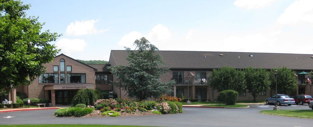 A large brick building with a parking lot in front of it