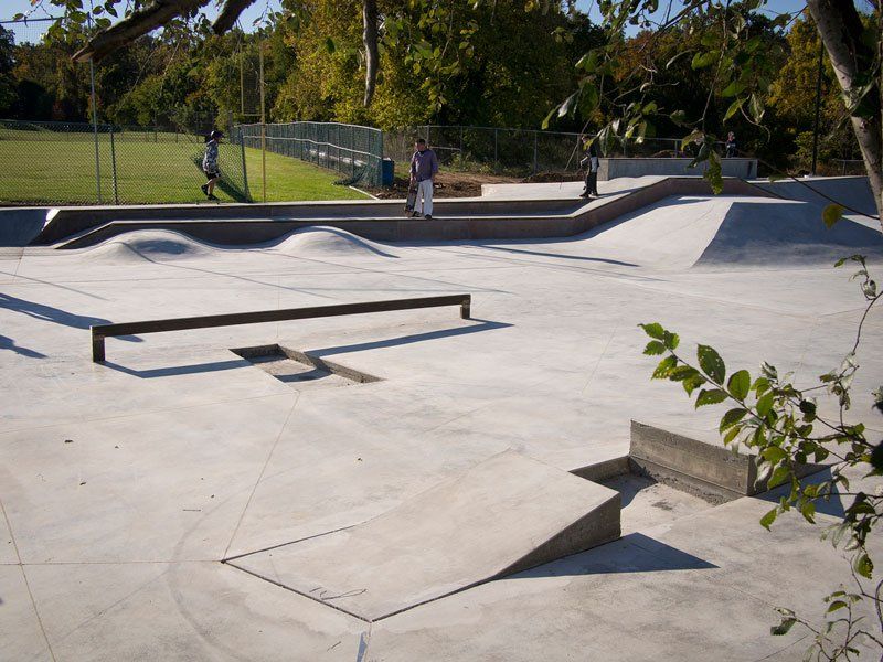 A person riding a skateboard on a ramp at a skate park