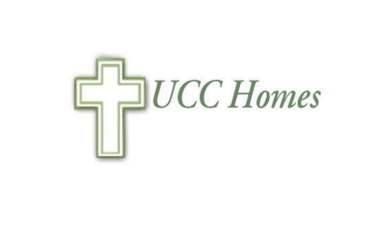 A logo for ucc homes with a cross on it