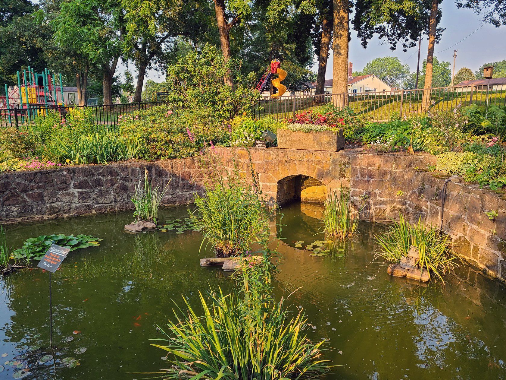A small bridge over a pond in a park