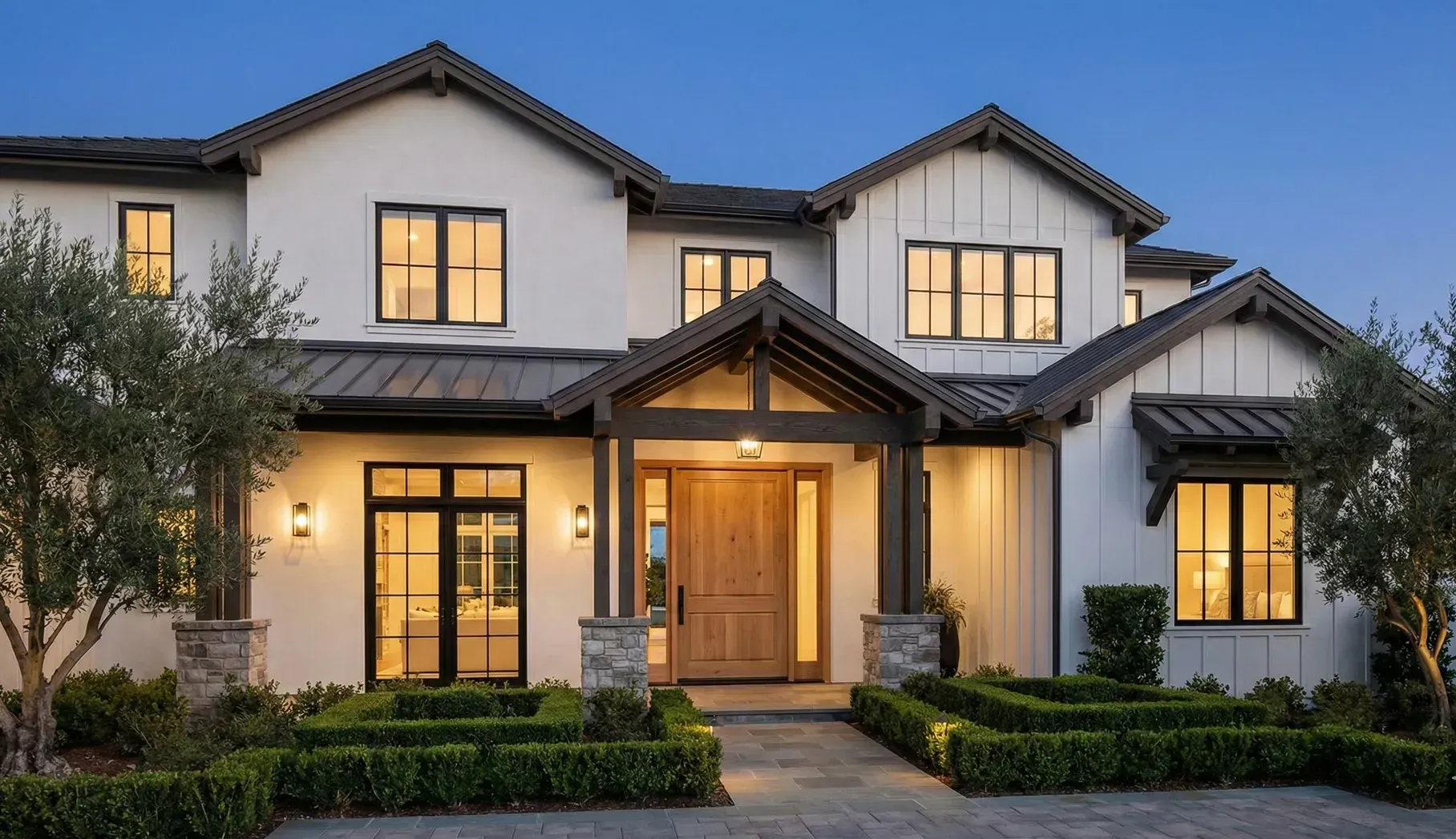 A large white house with a swimming pool in front of it.