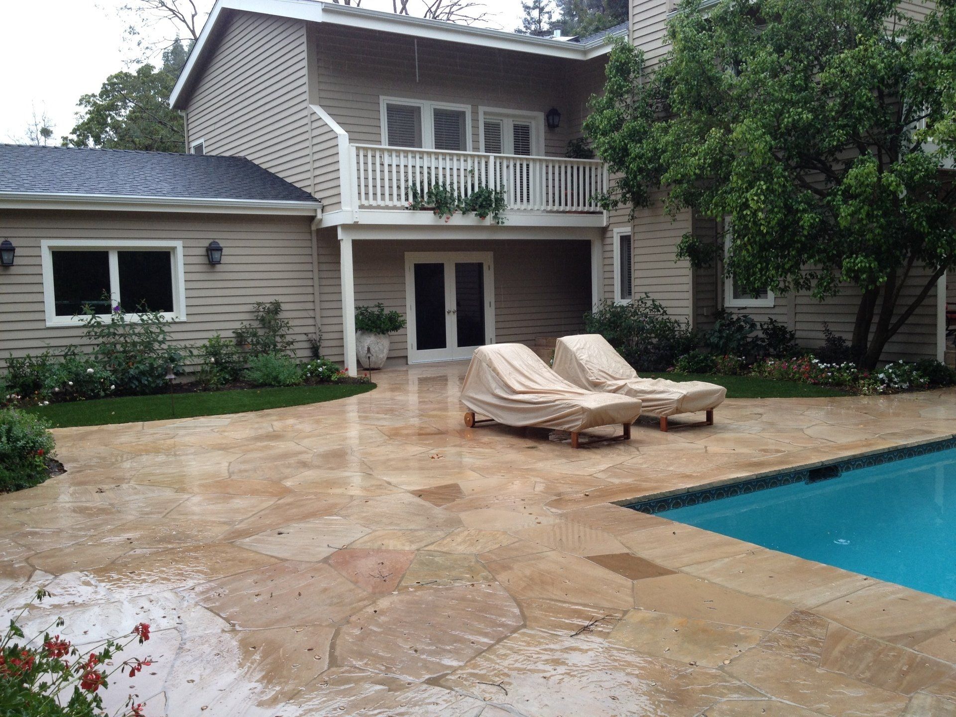 A large house with a swimming pool in front of it
