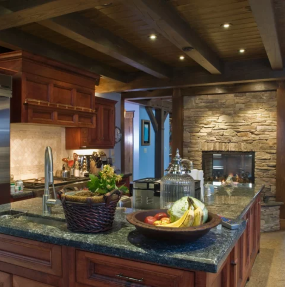 A kitchen with a bowl of fruit on the counter