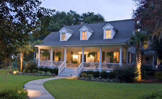 A house with a large porch and a walkway leading to it