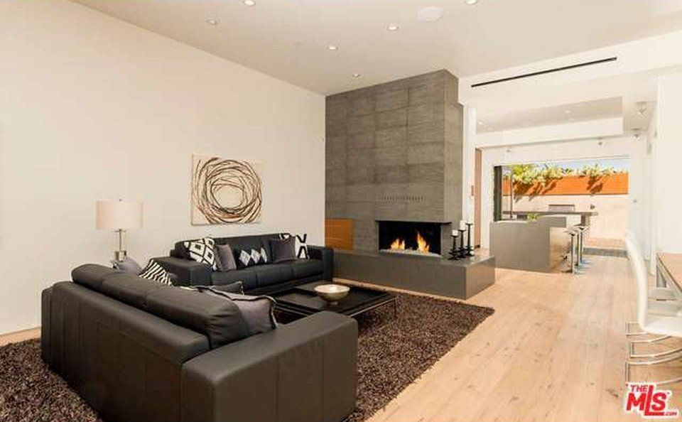 A living room with a couch , fireplace and rug.