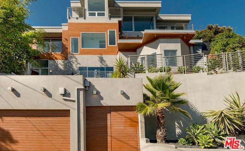 A large swimming pool with a view of a city at night