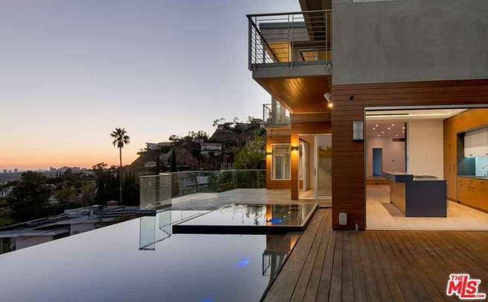 A modern house with a lot of windows and a fence