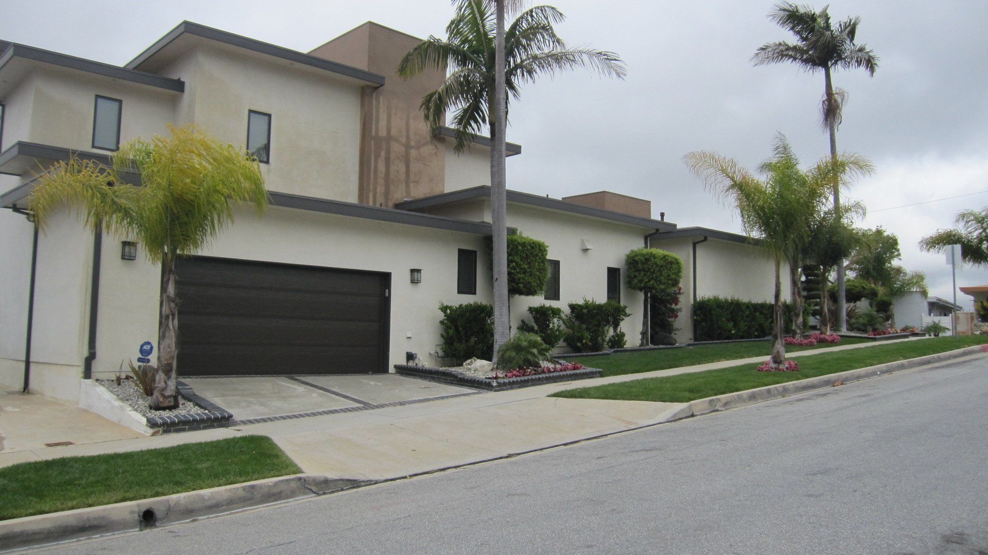 A large white house with a black garage door