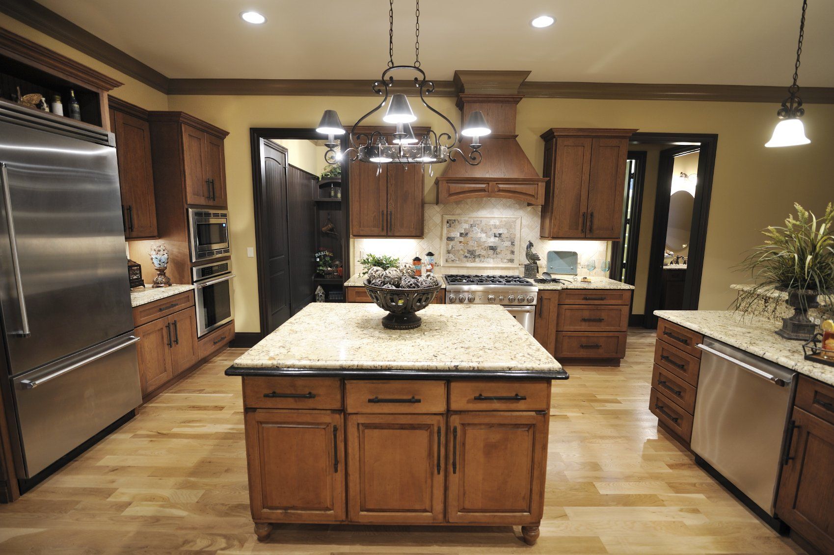 A kitchen with stainless steel appliances and wooden cabinets