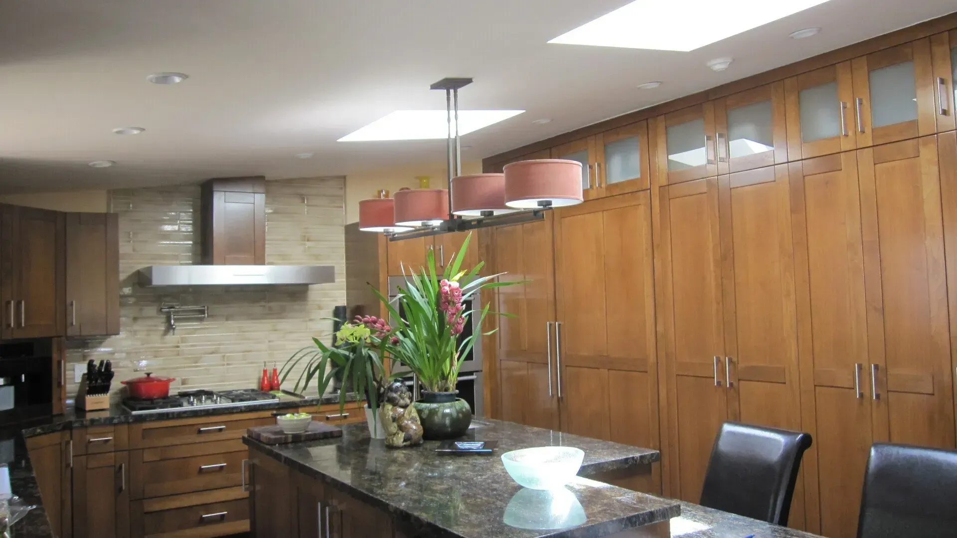 A kitchen with wooden cabinets and a granite counter top
