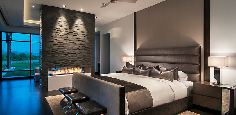 A bedroom with a king size bed and a fireplace