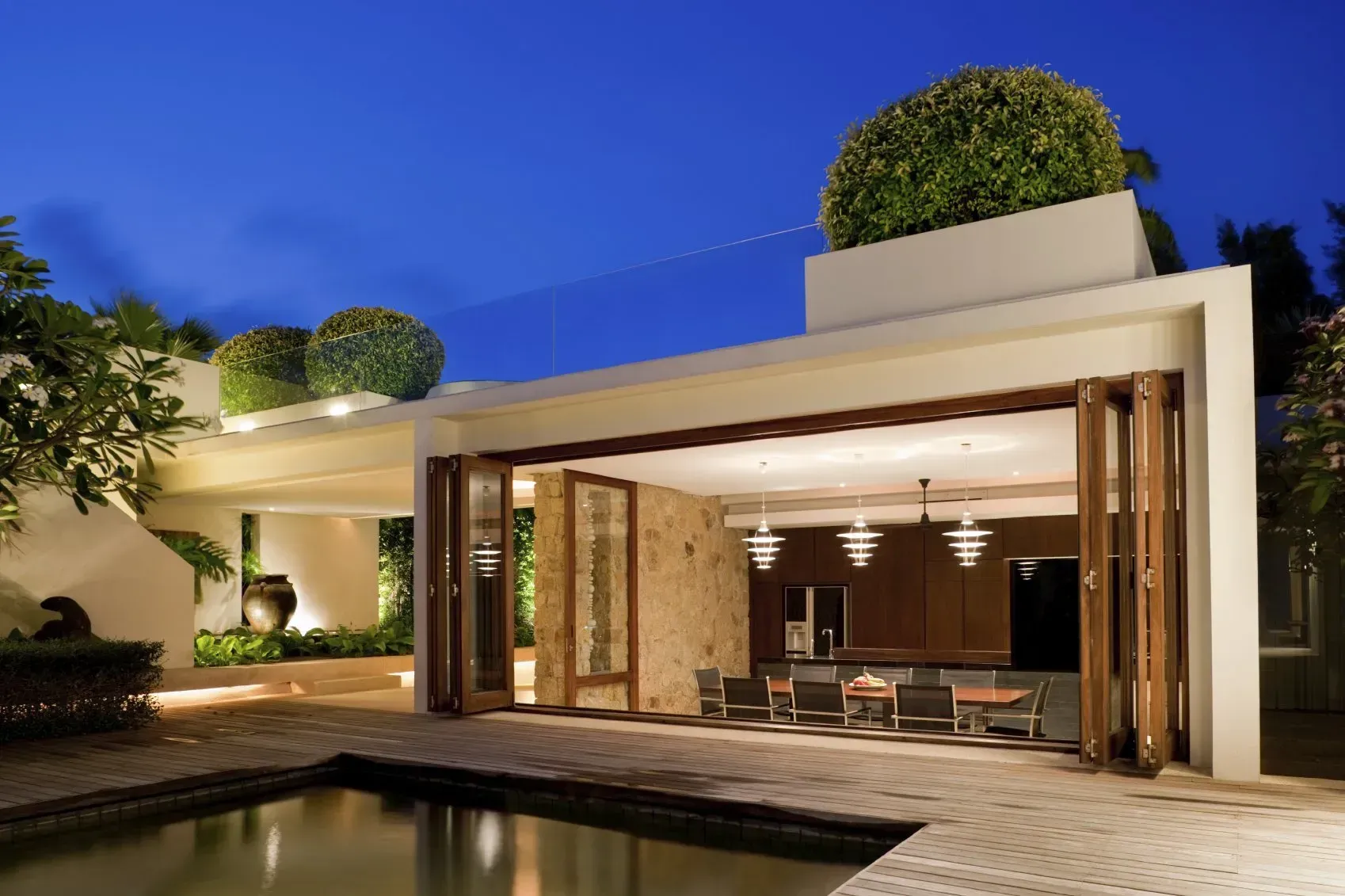 A house with a swimming pool in front of it