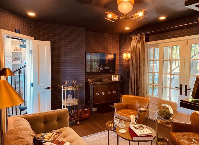 A living room with a couch , chairs , tables and a television.