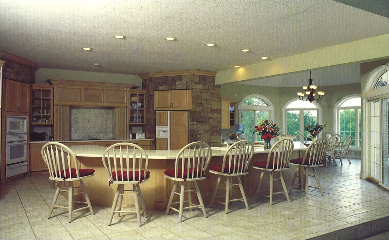 A kitchen with a large island and chairs