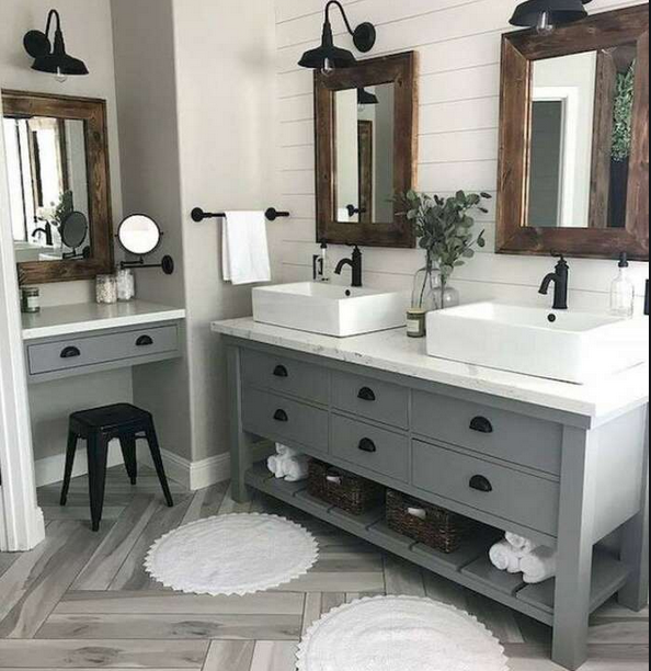 A bathroom with two sinks , two mirrors and a stool.