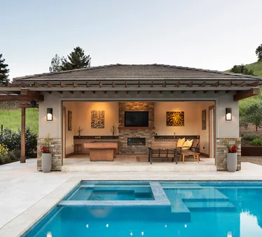 A house with a swimming pool in front of it