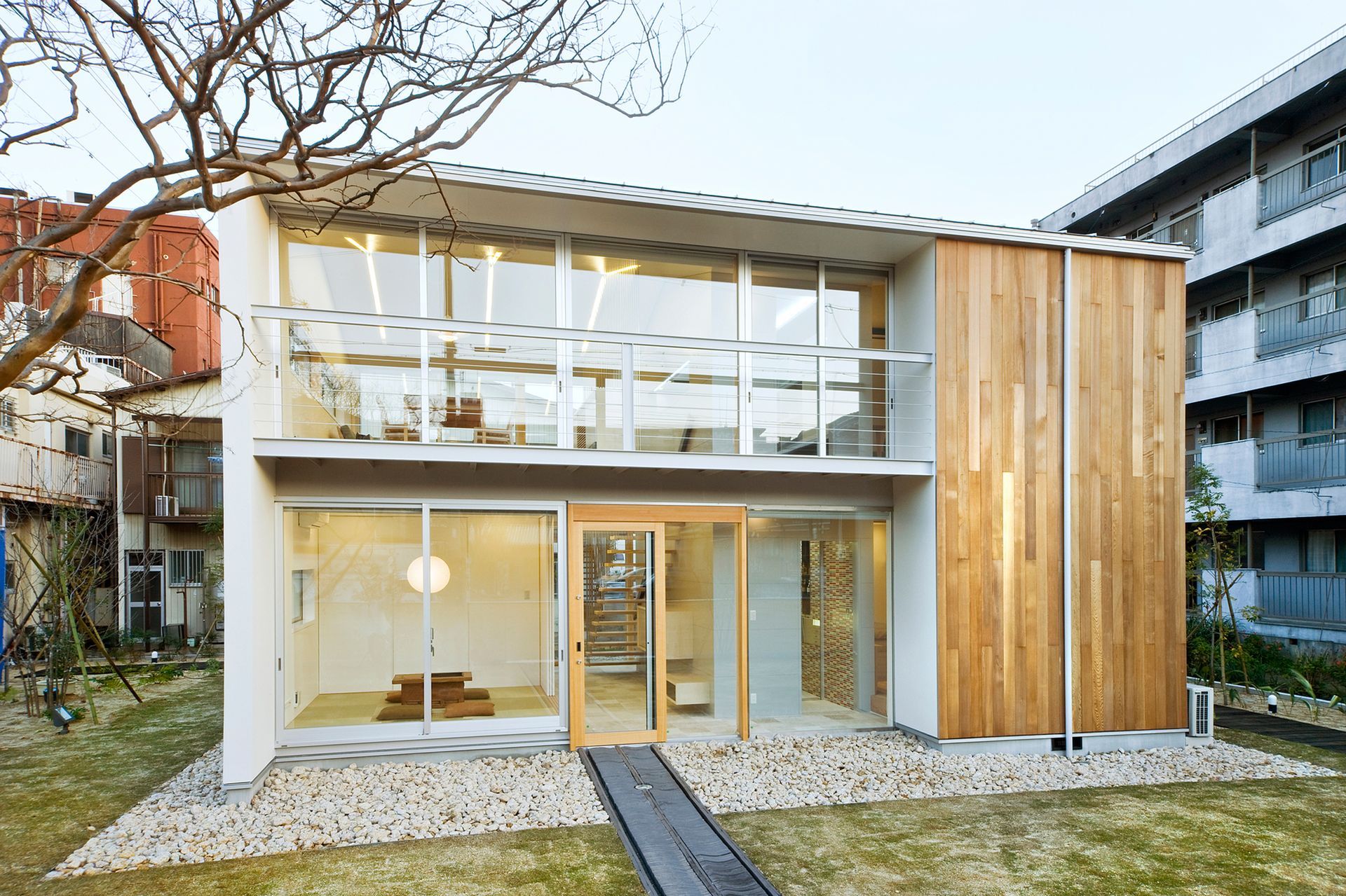 A modern house with a lot of windows and a fence