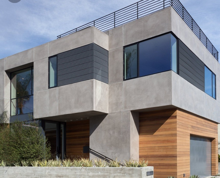 A modern house with a lot of windows and a fence