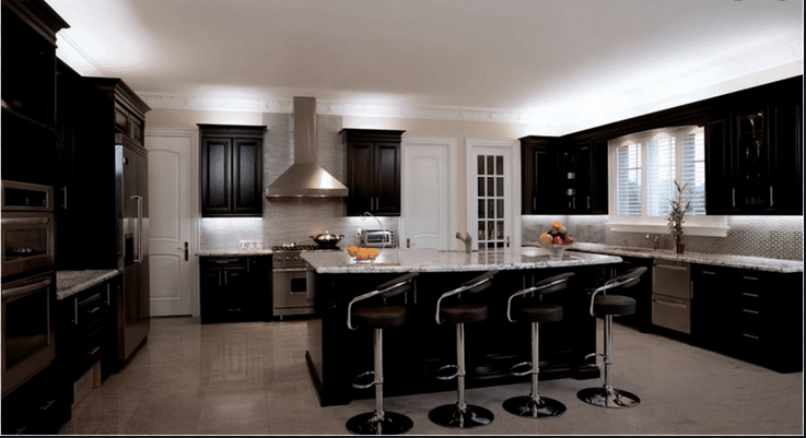 A kitchen with black cabinets and stainless steel appliances