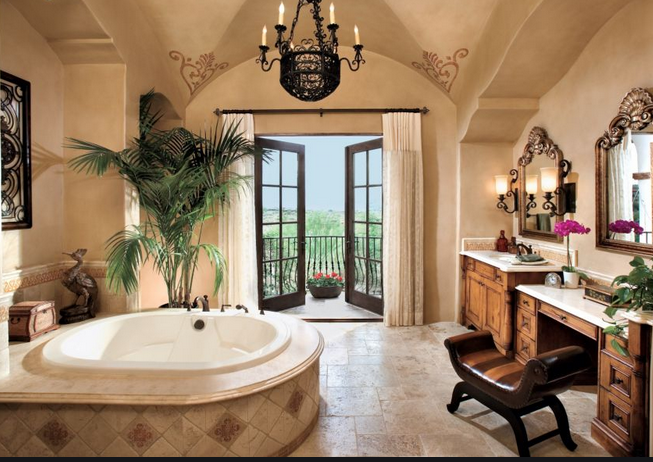 A bathroom with a large tub and a chandelier