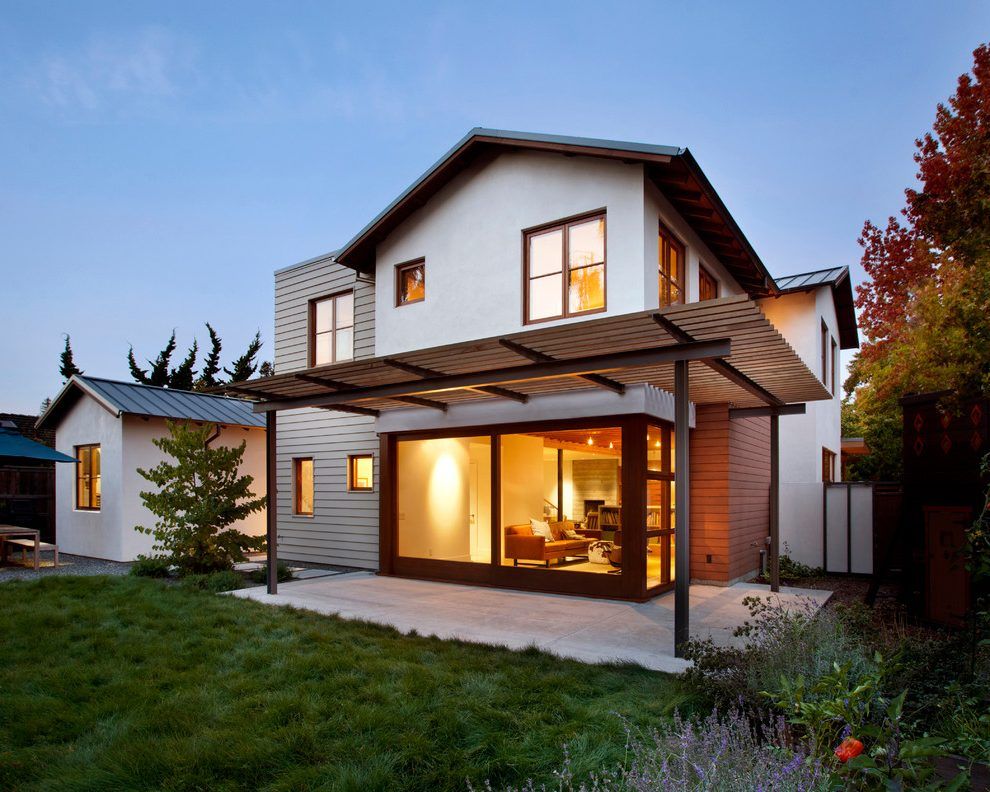 A house with a pergola and a lot of windows