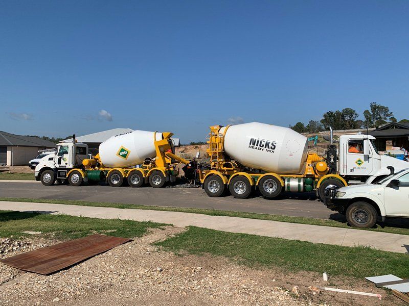 A Row of Concrete Trucks Are Parked in a Parking Lot — Nicks Readymix in Monkland, QLD