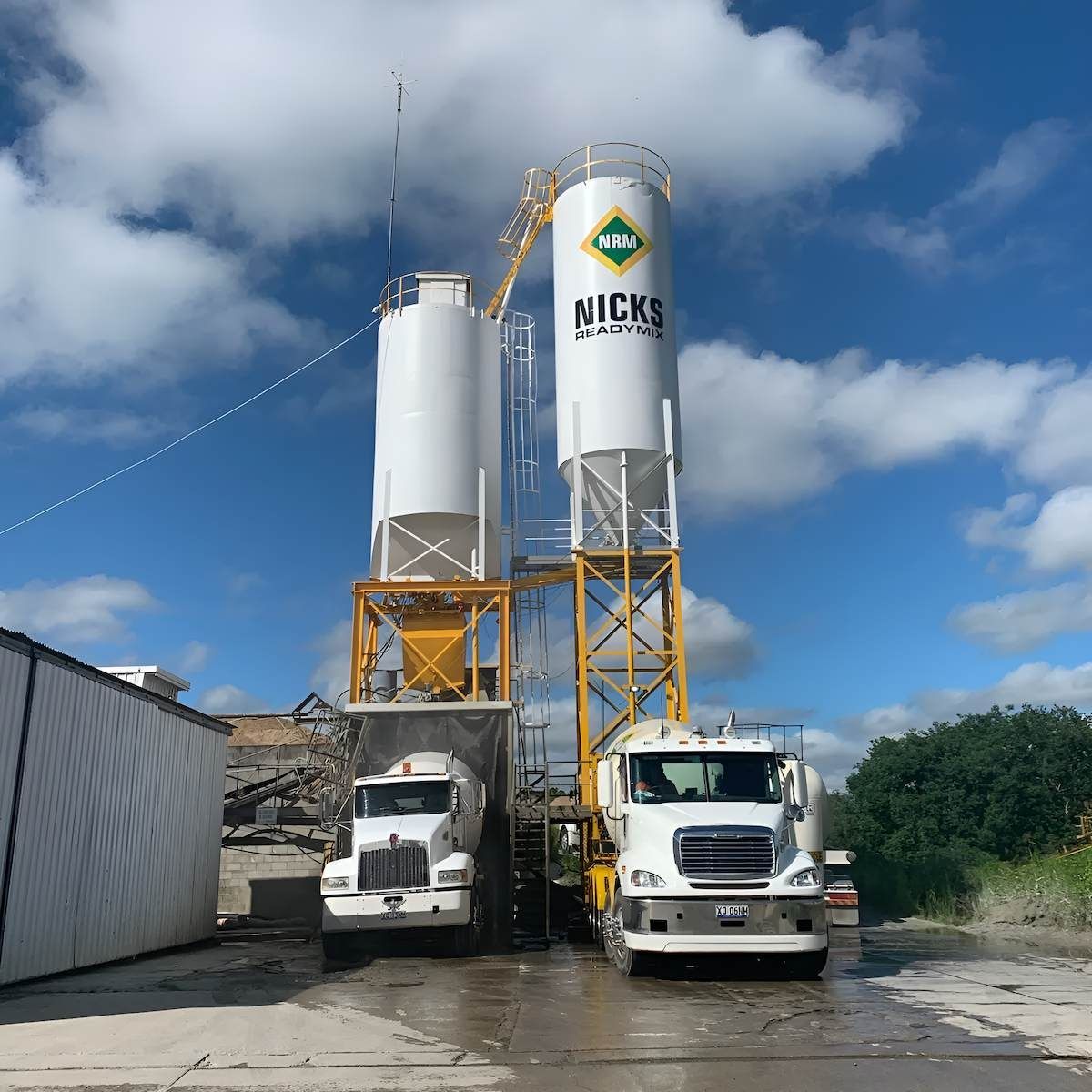 Two Trucks Are Parked in Front of a Silo That Says Nick 's — Nicks Readymix in Monkland, QLD