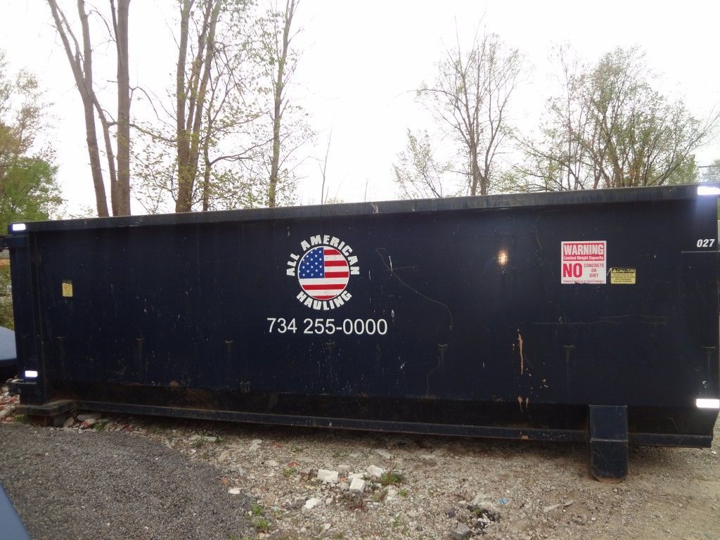 Black Dumpster in Empty Lot