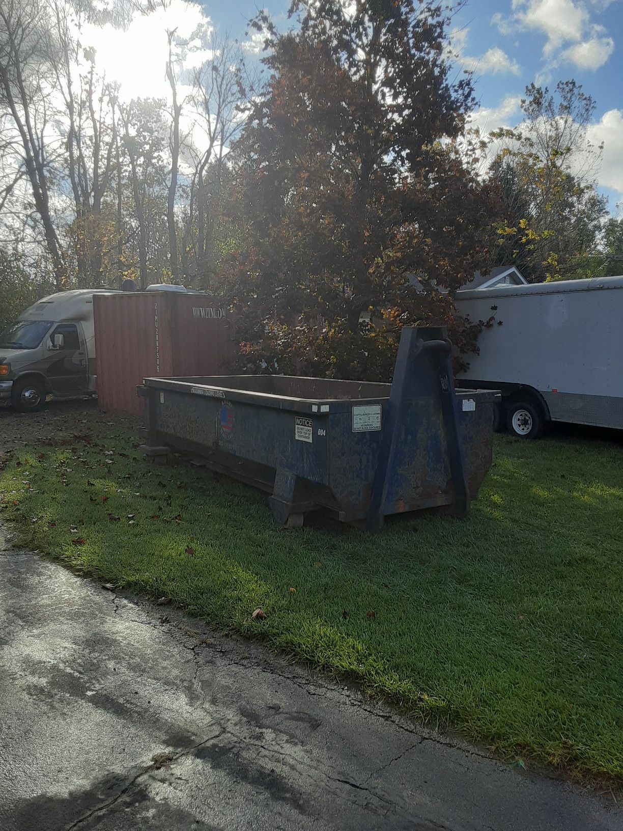 Black Dumpster in Empty Lot