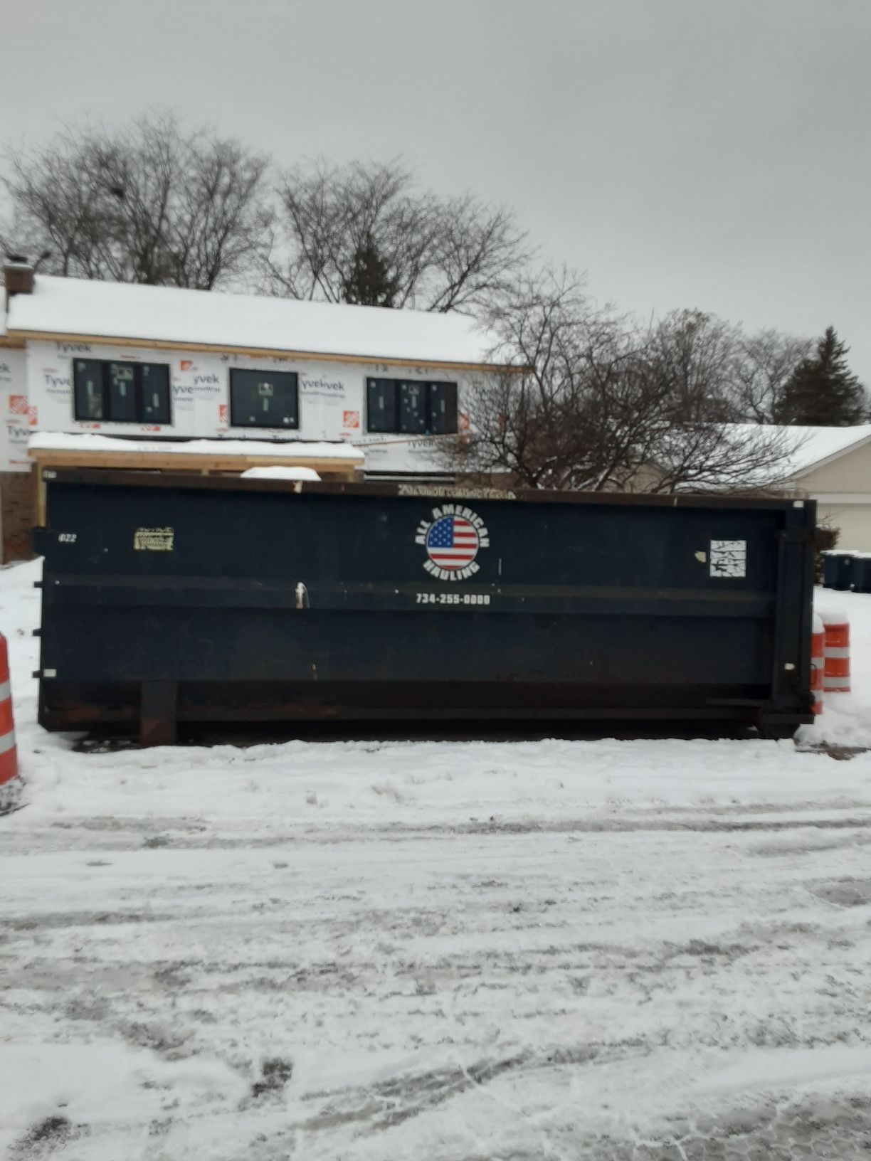 Black Dumpster in Empty Lot
