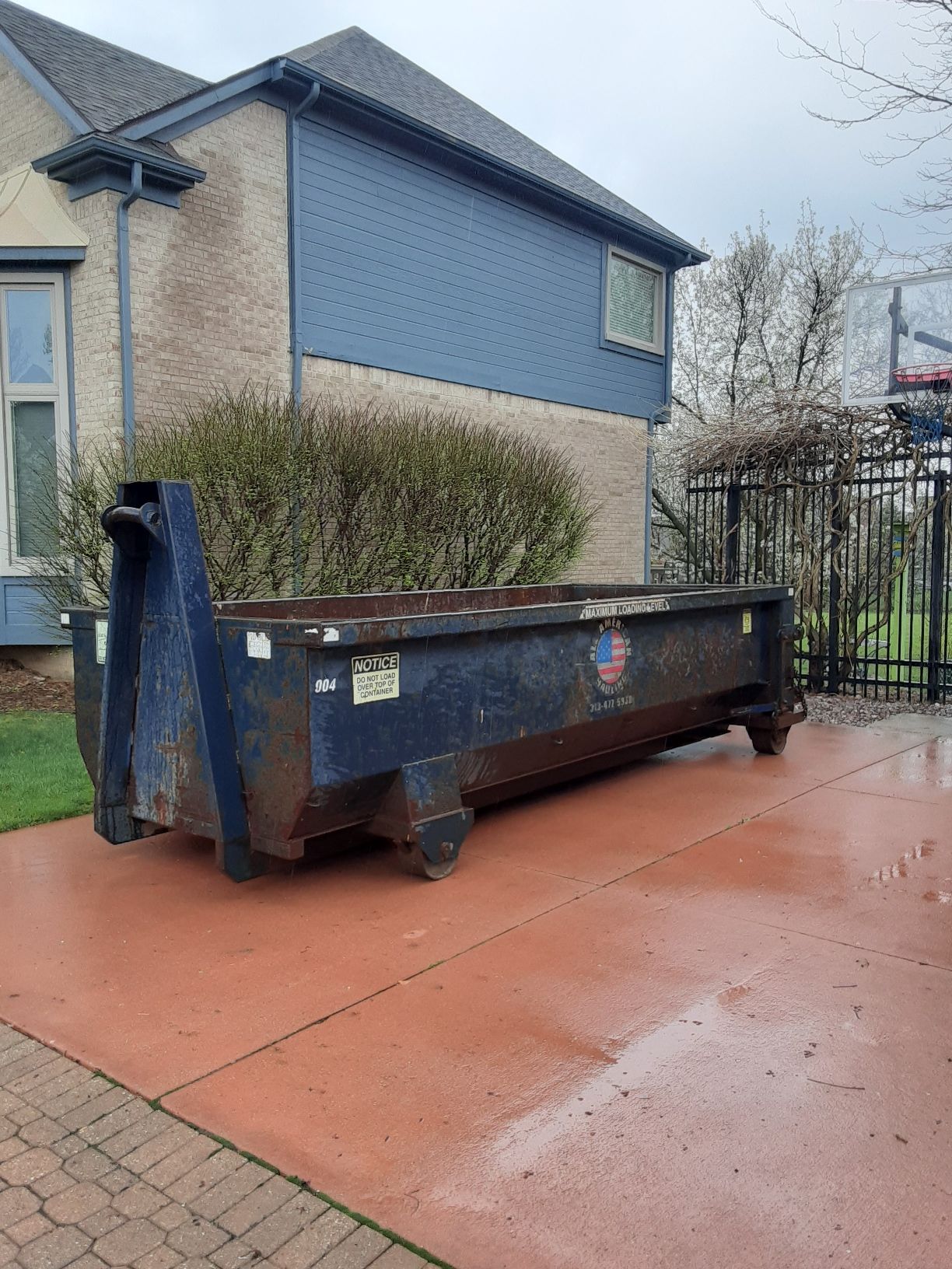 Black Dumpster in Empty Lot