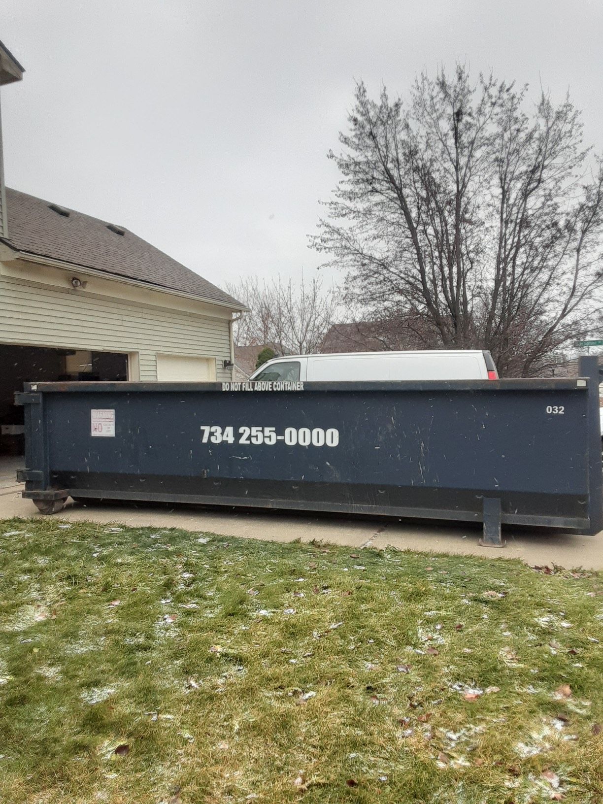 Blue Dumpster Truck Outside the Residential House