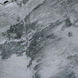 Gray marble surface with white veining and textured stone patterns