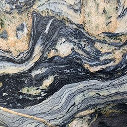 Swirling gray, black, and tan marbled stone pattern