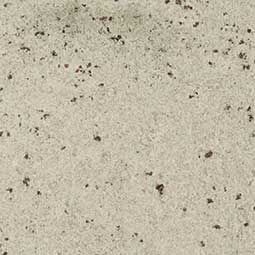 Light beige speckled stone or concrete surface with small dark flecks
