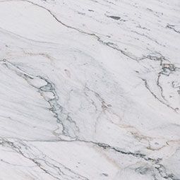 White marble surface with gray veining and subtle greenish tones