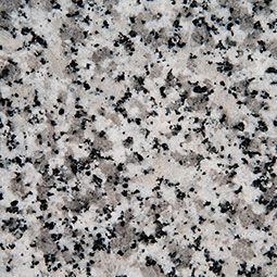 Speckled gray granite surface with black and white flecks
