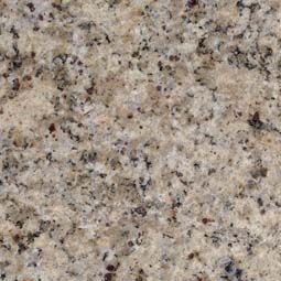 Close-up of speckled beige granite texture with black, brown, and gray flecks