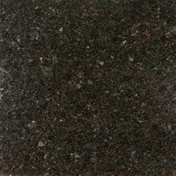 Dark speckled stone or granite surface with mottled brown, black, and gray tones