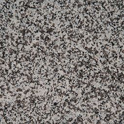Close-up of a gray, black, and white speckled granite surface