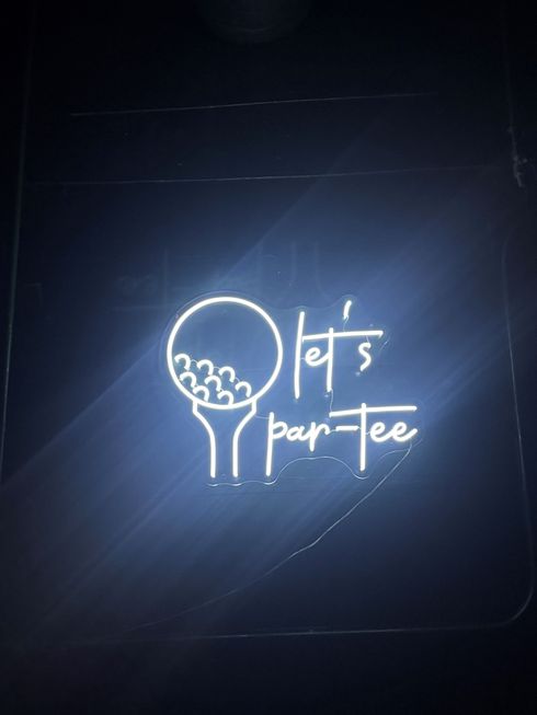 Golf balls scattered on green grass.