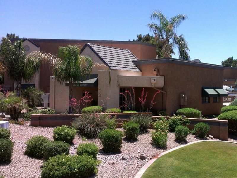 A house with a lot of bushes in front of it