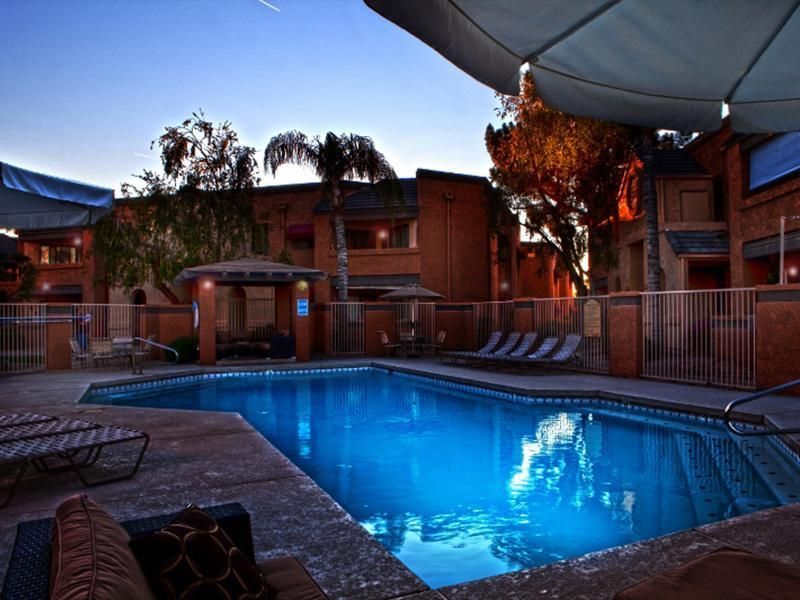 A large swimming pool with a fence around it