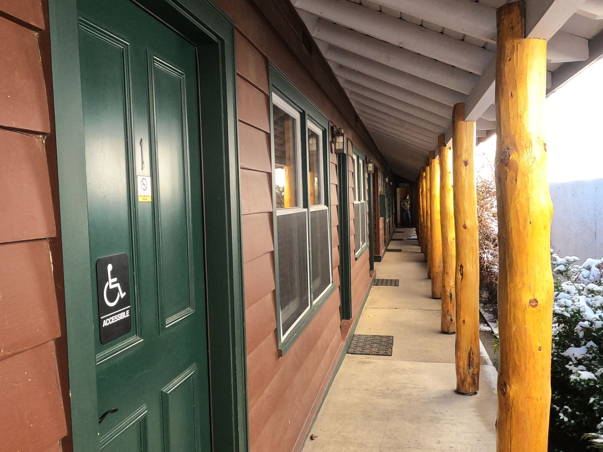 A green door with a handicap sign on it